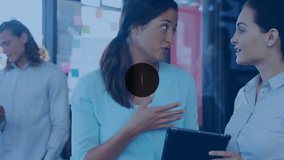 Animation of network of digital icons against two diverse women discussing at office. Global networking and business technology concept - Powered by Shutterstock - Get 15% off with code: PIKWIZARD15