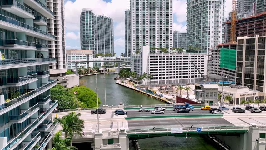 breathtaking Aerial View of Miami River with Luxury and 7star High Rise Apartments and Drawbridge Traffic. Corporates buildings and business apartments,