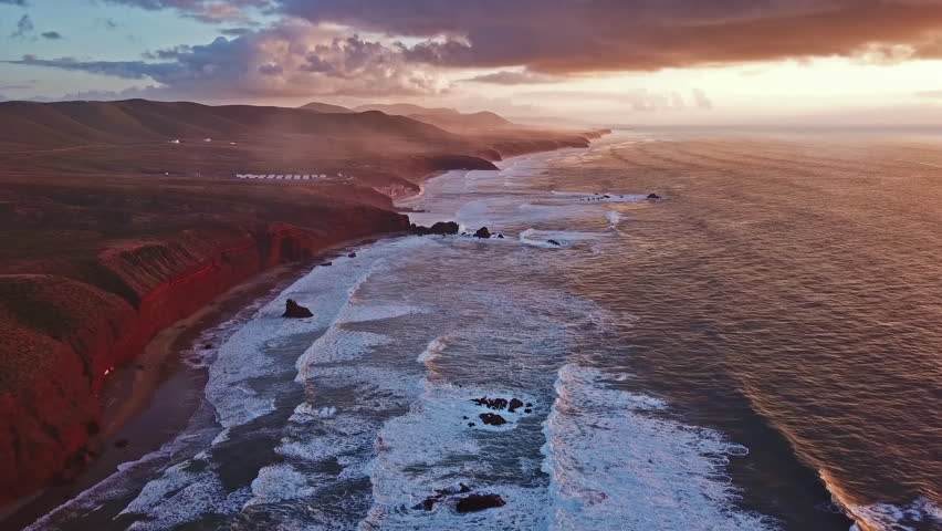 Aerial view on Legzira beach with arched rocks on the Atlantic coast at sunset in Morocco, 4k