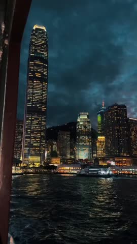 Stunning sunset over Victoria Harbour with Hong Kong skyline and iconic skyscrapers