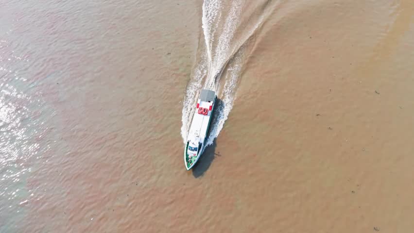 Aerial View Tilt of Ships Navigating the Saigon River.