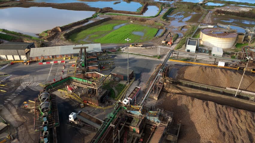 Top down drone footage showing industrial sugar processing tanks and complex pipework systems with brown water in Newark United Kingdom