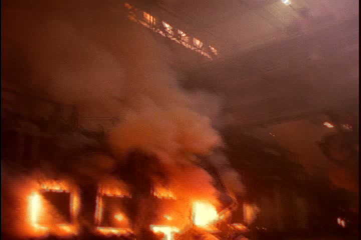 Steel works in Nizhny-Tagil, Russia. WS floor of steel plant with five flaming open hearth furnaces along back wall, huge ladle for moving molten ore is suspended from ceiling.