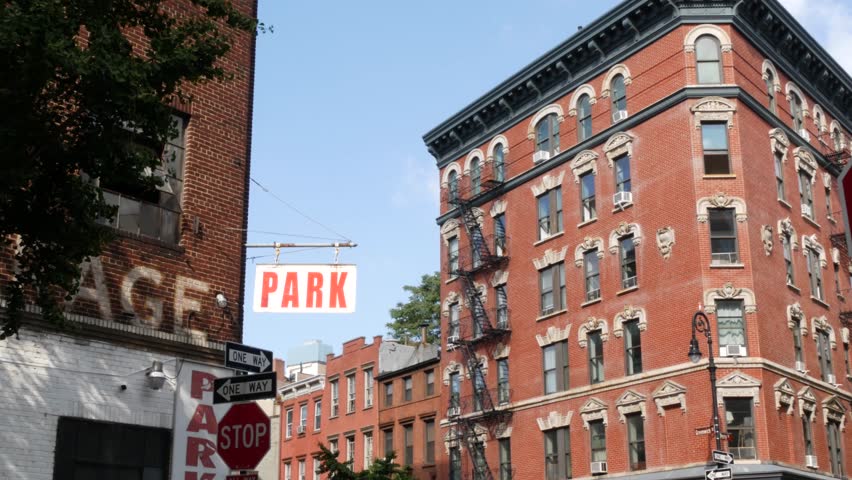 New York City urban residential buildings architecture, Manhattan West village Greenwich street corner, United States of America. Greenwich village Perry street, USA. Red brick house. Parking garage.