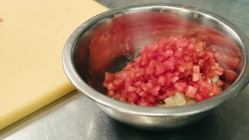 Chop tomato close up, Diced tomatoes on a cutting board for Italian sauce, chef cut tomatoes with knife. 