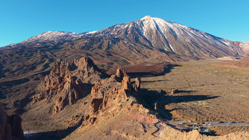 Morning mountain panorama, Vast wilderness captured at dawn with towering snowy mountains and calm sky. Teide. Tenerife. Spain