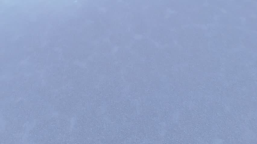 Aerial view of a serene picnic on the expansive Salar de Uyuni salt flats in Bolivia, capturing the unique reflection of clouds on the white surface