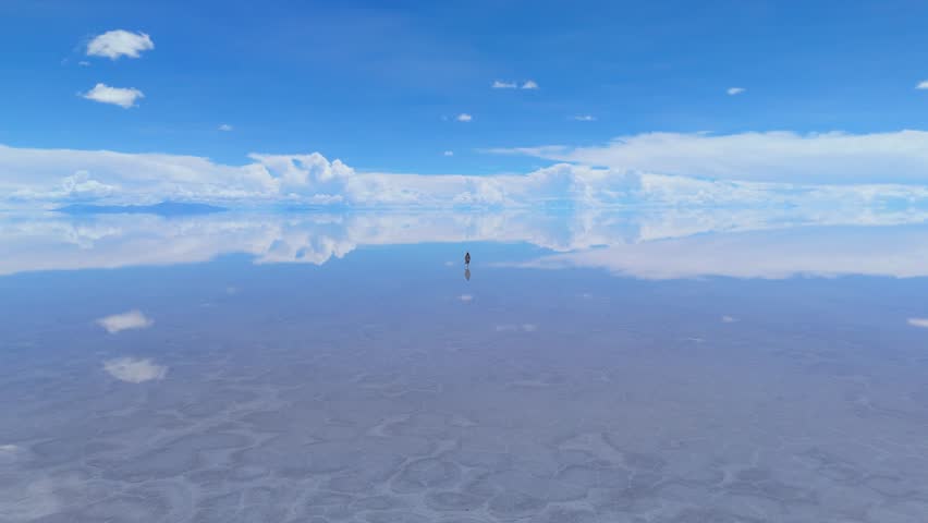 A breathtaking view of the Salar de Uyuni in Bolivia, capturing the vastness of the salt flats and the stunning reflection of the sky