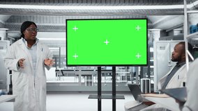 Mockup green screen used by medical school professor to do presentation for scientists during workshop. Woman teaching students using chroma key isolated screen display in lab, camera A - Powered by Shutterstock - Get 15% off with code: PIKWIZARD15