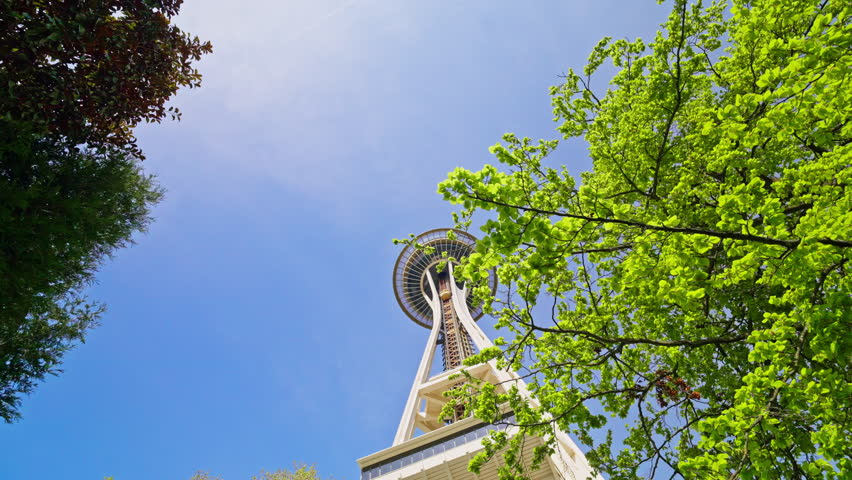 Moving shot from below toward the Space Needle in Seattle, Washington, highlighting its height and iconic structure from a low-angle perspective. Ideal for cityscape and landmark footage