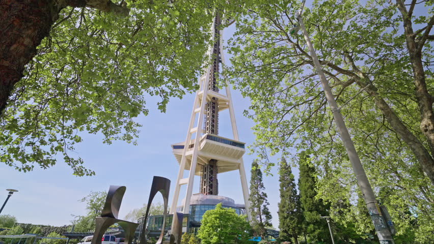 Moving shot from below toward the Space Needle in Seattle, Washington, highlighting its height and iconic structure from a low-angle perspective. Ideal for cityscape and landmark footage