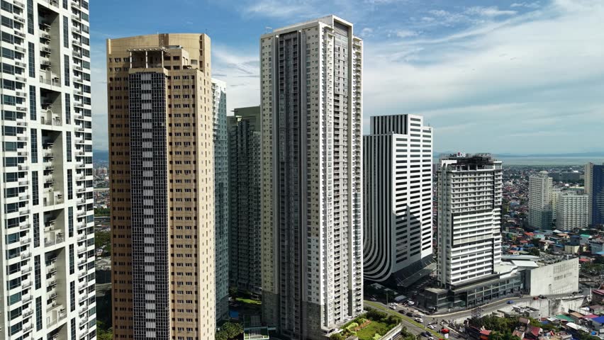 Compelling aerial footage presents multiple residential high-rise structures in Bonifacio Global City, Manila