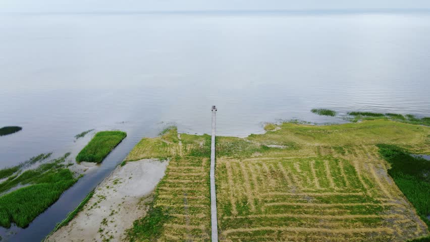Overcast summer day with Baltic shoreline and cyclists paused at trail end