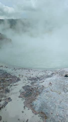 active geothermal activity in the form of hot mud eruptions, thick clouds of sulfur smoke, and colorful hot water pools that emit dangerous gases