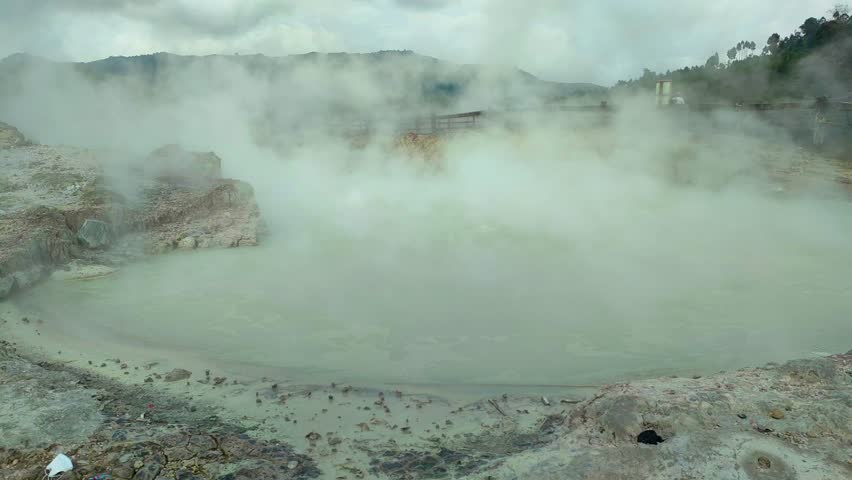 active geothermal activity in the form of hot mud eruptions, thick clouds of sulfur smoke, and colorful hot water pools that emit dangerous gases