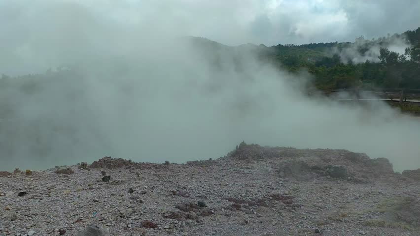 active geothermal activity in the form of hot mud eruptions, thick clouds of sulfur smoke, and colorful hot water pools that emit dangerous gases