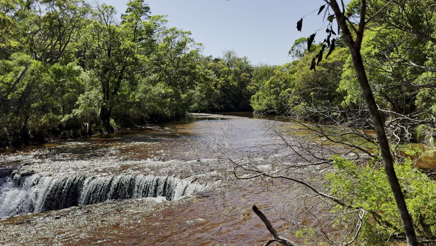 water cascading down beautiful elliot falls along the old telegraph track at cape york in tropical north Queensland, a popular travel destination for 4x4 enthusiasts.