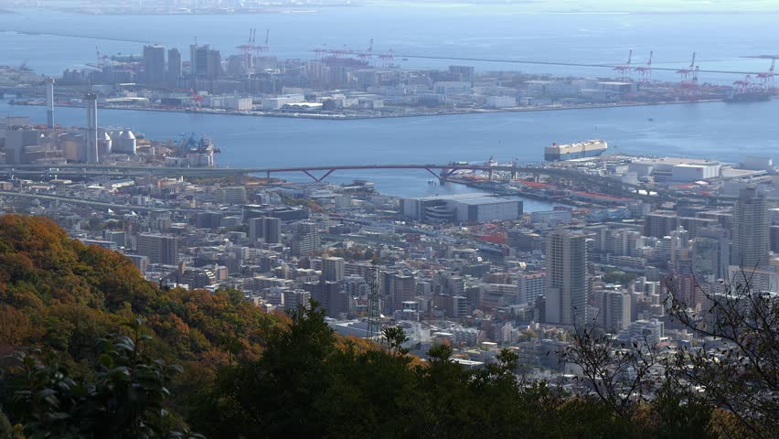 Cityscape skyline of Kobe Japan toward Osaka, industrial waterfront