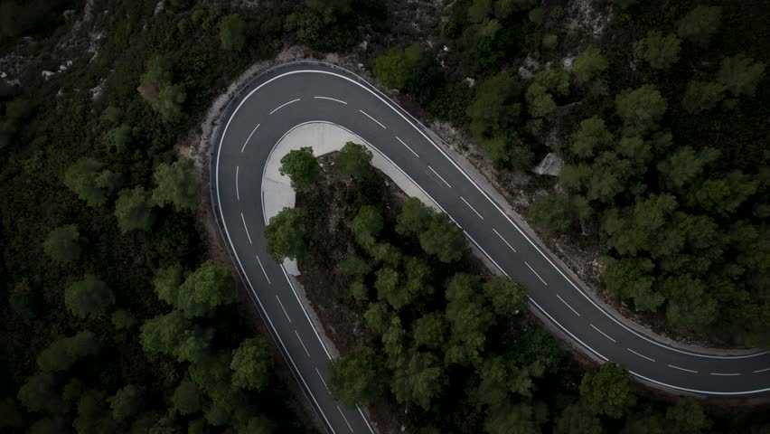 Car driving along a beautiful mountain road. High quality 4k drone footage