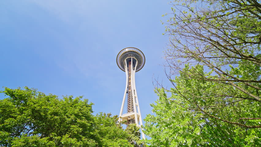 Moving shot from below toward the Space Needle in Seattle, Washington, highlighting its height and iconic structure from a low-angle perspective. Ideal for cityscape and landmark footage