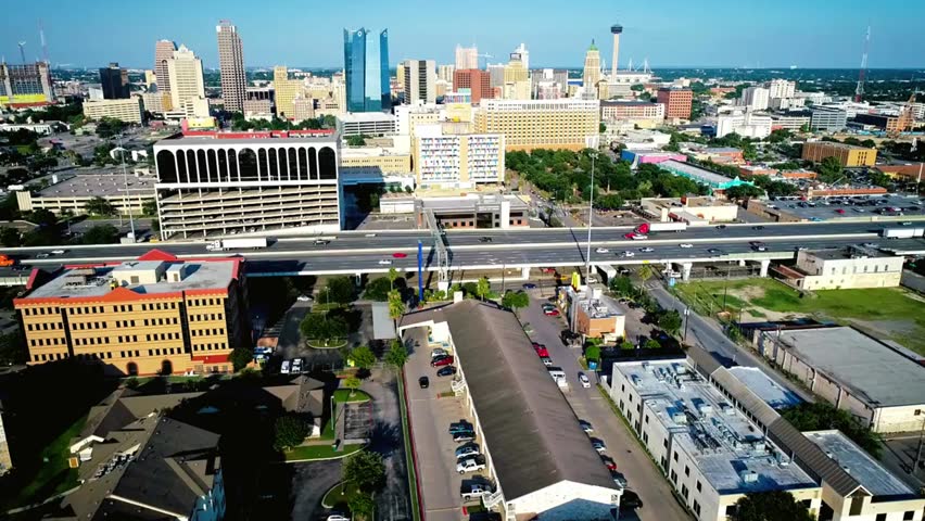 Aerial view of downtown San Antonio, Texas, showcasing cityscape, highways, and urban life, ideal for travel, architecture, and business content.