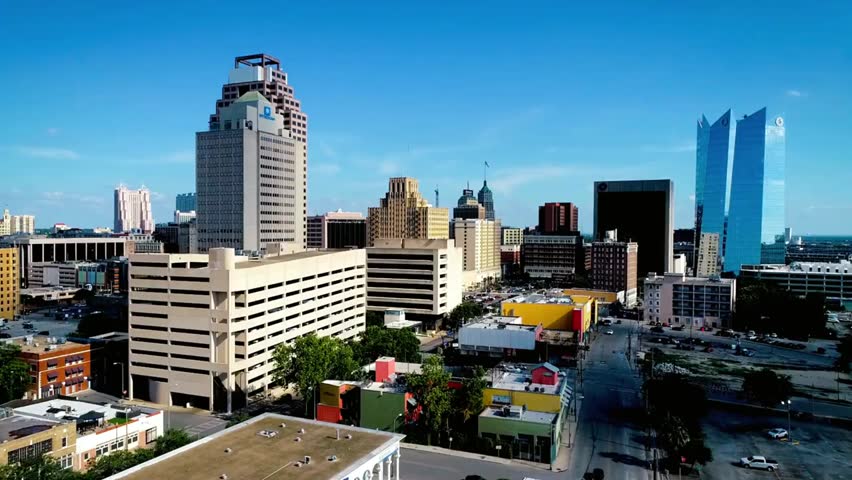 Modern San Antonio skyline with high-rise buildings under a clear blue sky, showcasing urban architecture, cityscape, and metropolitan life.
