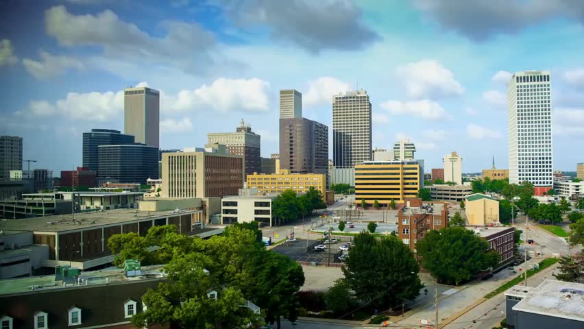 Panoramic view of Tulsa, Oklahoma city skyline with modern skyscrapers and urban architecture under a clear sky, showcasing downtown growth and city life.
