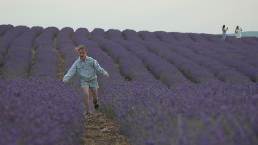 Girl running lavender. Happy child explores beautiful purple field, enjoying freedom and summer bliss.