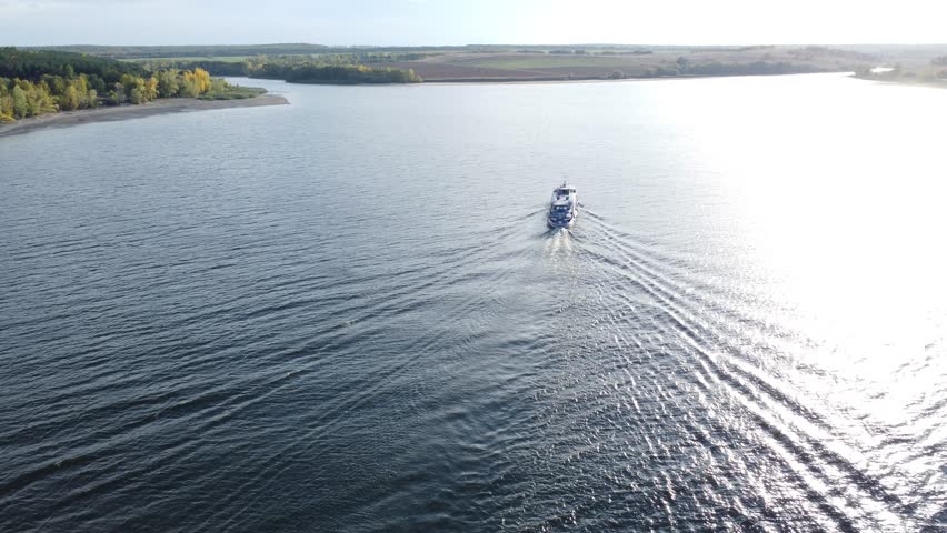 Aerial view of a tourist boat cruising on a river