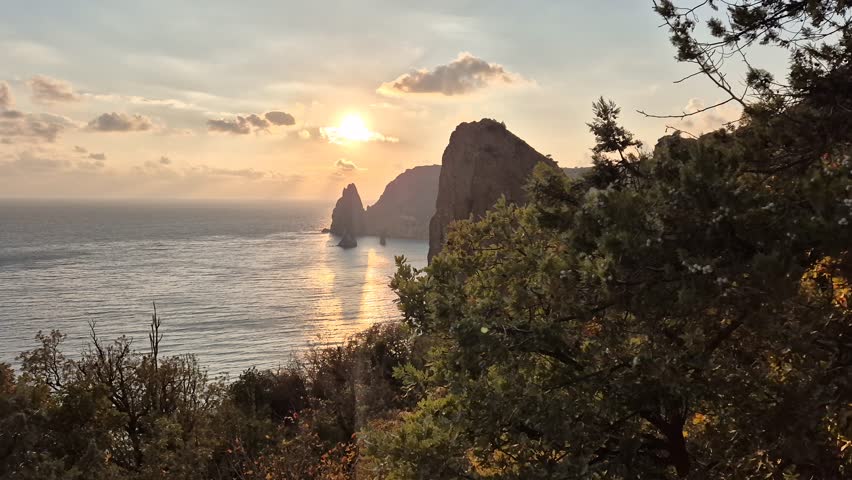 Sea sunset rocks golden light ocean horizon dramatic coastal cliffs serene natural beauty peaceful seascape