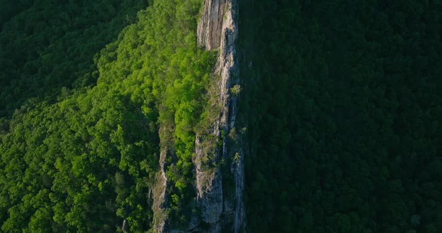 Overhead drone view of Seneca Rocks cliff ridge in Appalachia at sunset