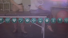 Animation of connections and medical icons over caucasian male physiotherapist and patient. Health, medicine, connections and technology concept digitally generated video. - Powered by Shutterstock - Get 15% off with code: PIKWIZARD15