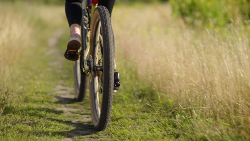 Woman Cycling MTB Bike Riding. Cyclist Mountain Bike. Athlete On MTB Bicycle Cycling In Park. Sport Recreation. Cycling On Hardtail Bike Mtb In Field. Woman Cyclist Workout Exercise Cross-Country