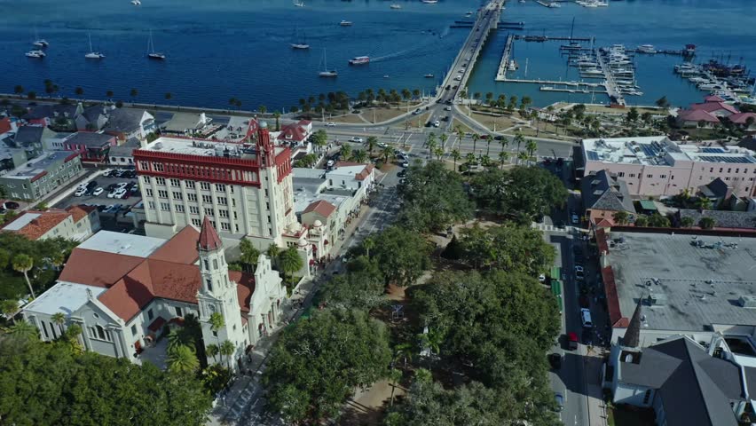 Historic buildings and urban parklands sit adjacent to a marina full of boats along the waterfront of St. Augustine, showcasing the city’s charm and coastal lifestyle.