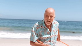 Animation of do it for them over happy caucasian senior man with hula hoop on beach. staying at home, self isolation during covid 19 pandemic and holidays concept digitally generated video. - Powered by Shutterstock - Get 15% off with code: PIKWIZARD15