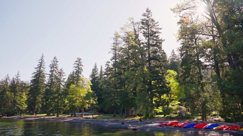 Lake Crescent in Olympic National Park, Washington, with clear blue water, forested shores, and mountain scenery. Ideal for nature, travel, and landscape footage.