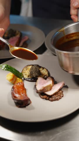 A person is cooking food on a plate with a spoon. The plate has meat and vegetables on it