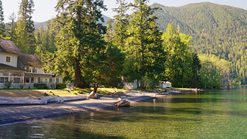 Lake Crescent in Olympic National Park, Washington, with clear blue water, forested shores, and mountain scenery. Ideal for nature, travel, and landscape footage.
