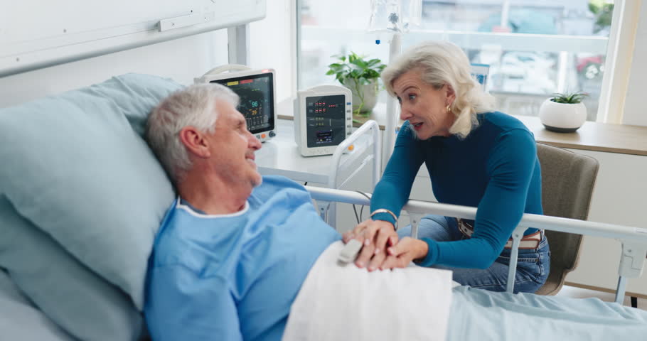 Conversation, love and woman with husband in hospital bed for surgery recovery, healing or treatment. Happy, retirement and senior couple with talking in medical clinic for visit with marriage.