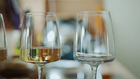 Slow motion close up, white wine being poured into glass in daylight kitchen - Powered by Shutterstock - Get 15% off with code: PIKWIZARD15