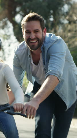 Father, kid and push bicycle for learning outdoor, happiness and development with family together. Ride bike, cycling and parent with girl child for teaching, support and help excited daughter