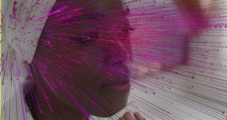 Woman holding phone, fixing wrap and speaking during tech call, magenta streaks sweeping over face. Profile, headscarf, necklace, beads, pink, purple, radial