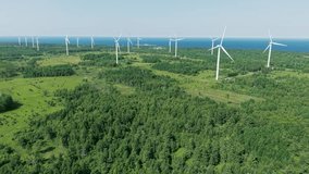 Aerial drone footage of wind turbines and solar panels at a renewable energy plant in a natural landscape near Paldiski, Estonia. - Powered by Shutterstock - Get 15% off with code: PIKWIZARD15