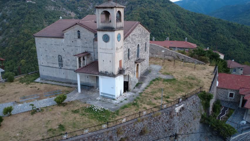 Isolated Orthodox Church With Stone Bell Tower Above Forested Mountain Gorge
