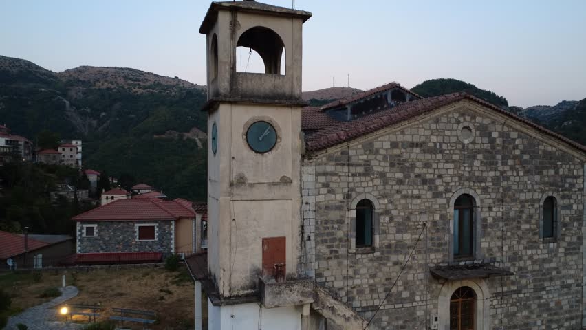 Old Orthodox Church Bell Tower With Clock In Quiet Mountain Village At Dusk