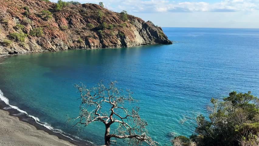 Coastal landscape in Turkey near Antalya, Kemer and Cirali with turquoise sea, rocky cliffs and clear water. Peaceful Mediterranean shoreline and natural scenery