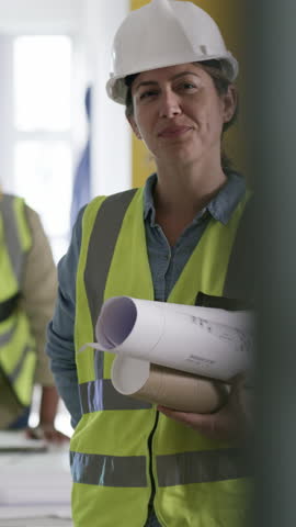 Blueprints, woman and face of civil engineer on site with confidence for project development. Happy, safety gear and portrait of female construction manager with drawings for infrastructure building.