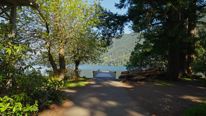 Lake Crescent in Olympic National Park, Washington, with clear blue water, forested shores, and mountain scenery. Ideal for nature, travel, and landscape footage.