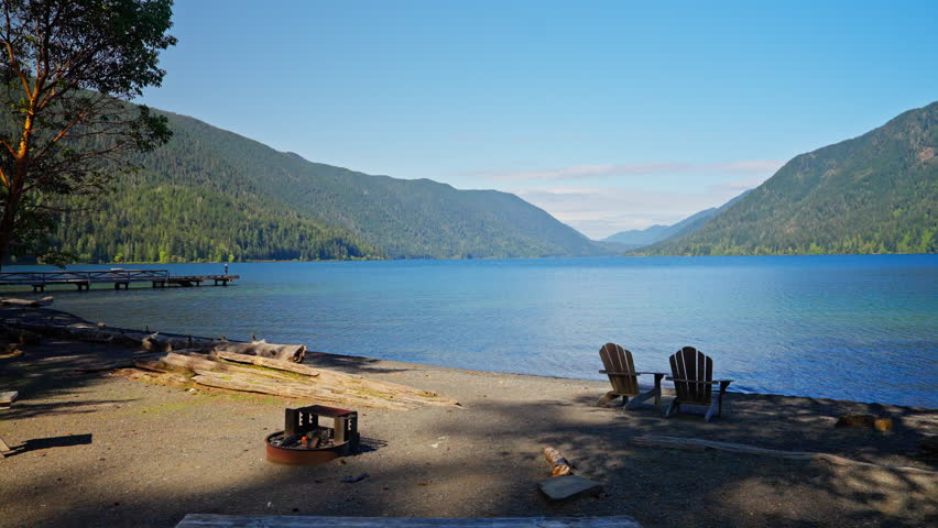 Lake Crescent in Olympic National Park, Washington, with clear blue water, forested shores, and mountain scenery. Ideal for nature, travel, and landscape footage.