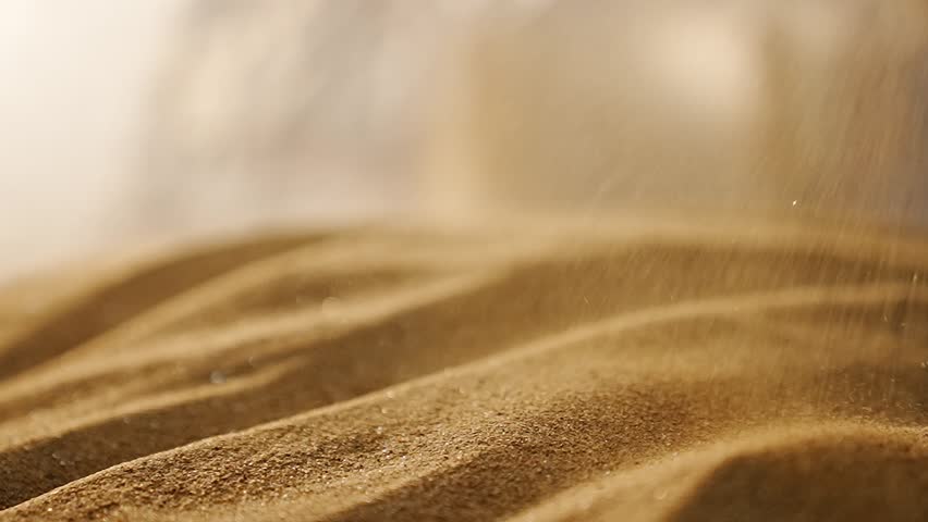 The strong wind in the desert blows fine sand particles